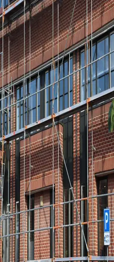 A vertical scaffolding structure attached to a building